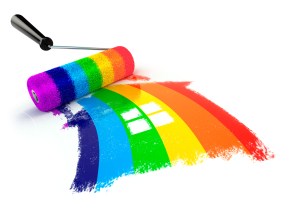 Construcrion concept.Roller brush with sign of house in rainbow